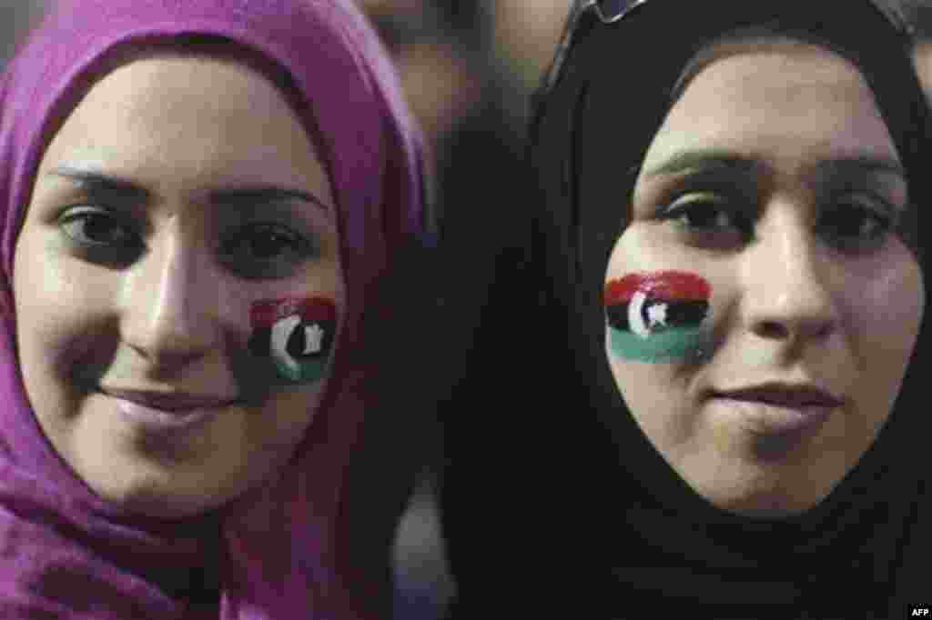 Alaa Elshiekh, right, and her sister Yosev Elshiekh, celebrate the revolution against Moammar Gadhafi's regime and ask for more women's rights in Tripoli, Libya, Friday, Sept. 2, 2011. Rebel forces are advancing toward Moammar Gadhafi's hometown Sirte des