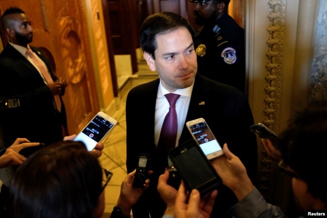 FILE - U.S. Sen. Marco Rubio (R-FL), an Intelligence Committee member, speaks to reporters outside the Senate floor in Washington, July 17, 2018.