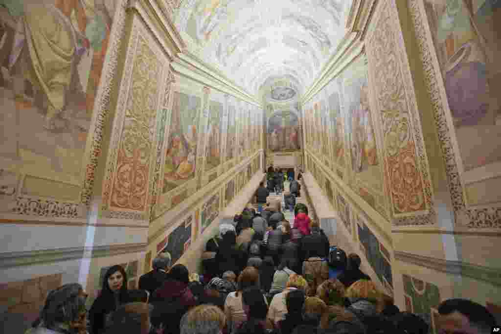 People kneel on the newly repaired Holy Stairs (Scala Sancta), which, according to Catholic Church, are the stairs on which Jesus Christ walked leading on his way to the crucifixion, during a special opening, in Rome, Italy.