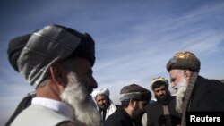 Members of the Afghan parliament congratulate each other after an inauguration ceremony in Kabul January 26, 2011.