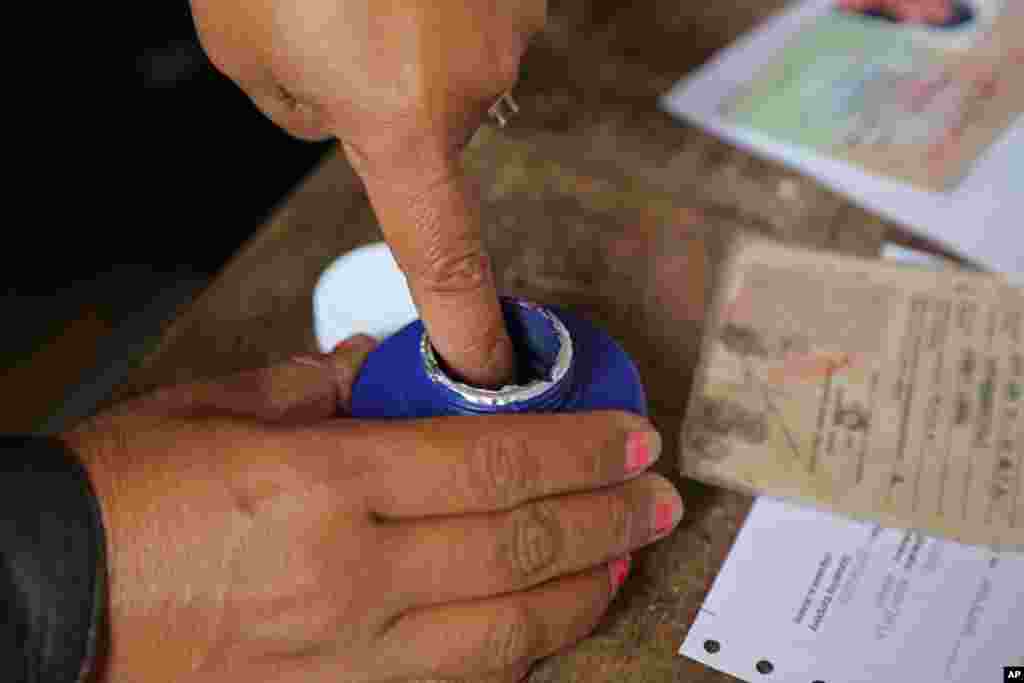 Å woman's finger is marked with ink after she cast her ballot in Antananarivo, Madagascar, Oct. 25, 2013.