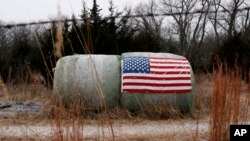 A U.S. flag is attached to a hay bale on a farm in Crete, Nebraska, Jan. 4, 2017. 