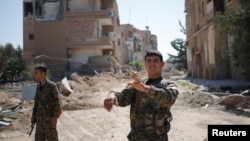 A Kurdish fighter from the People's Protection Units (YPG) is shown in Raqqa, Syria, June 27, 2017. 