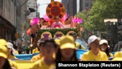 Anggota Falun Gong atau Falun Dafa, sebuah kelompok spiritual China, berpawai menuju Konsulat Jenderal Republik Rakyat China di Kota New York, 16 Mei 2019. (Foto: Shannon Stapleton/Reuters) 
