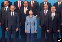 European Council President Donald Tusk (L), South Korea's President Park Geun-hye (C), Russia's Prime Minister Dmitry Medvedev (R), and others pose for a group photo of leaders at the 11th Asia-Europe Meeting (ASEM) in Ulaanbaatar, Mongolia on July 15, 2016.