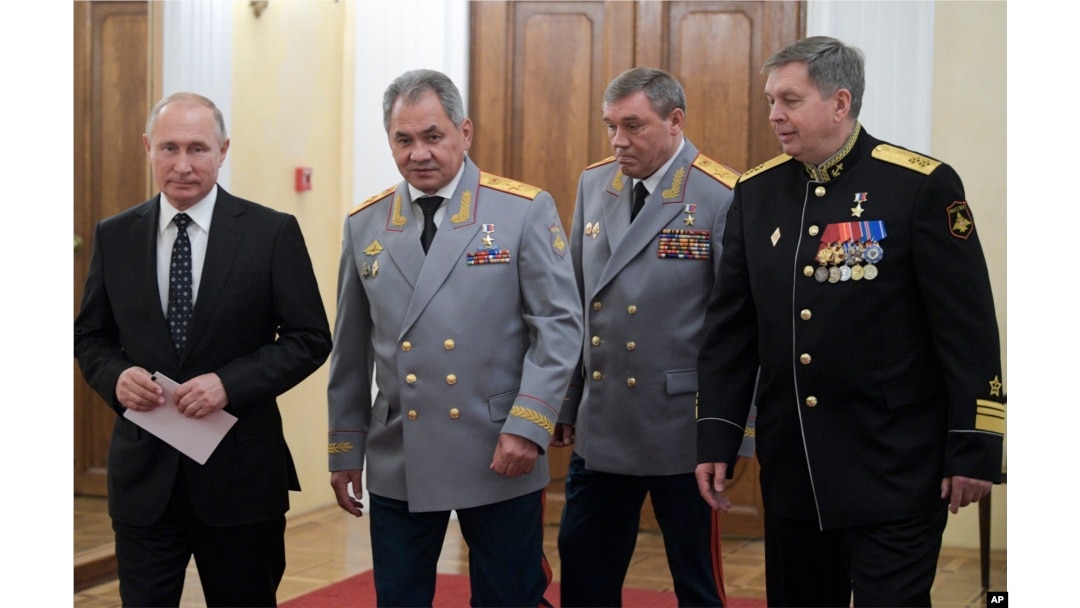 From the left: Russian President Vladimir Putin, Defense Minister Sergei Shoigu, Head of the General Staff of the Armed Forces of Russia and First Deputy Defense Minister Valery Gerasimov, and Deputy GRU chief, Vice Adm. Igor Kostyukov walk to attend a meeting marking the centenary of Russia's military intelligence, GRU in Moscow, Russia, Nov. 2, 2018.