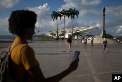 Gabriele Roza, a reporter for Agencia Publica who helped develope the "Museum of Yesterday" app holds a cell phone in Praca Maua, at the heart of the renovated port area in Rio de Janeiro, Brazil, July 6, 2017.