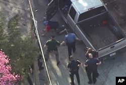 This aerial image made from a helicopter video provided by WHDH shows Richard Simone kneeling and putting his hands on the ground after a high-speed police pursuit in Nashua, New Hampshire, May 11, 2016.