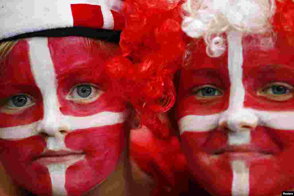 Young Denmark fans with their faces painted in the colors of the Danish flag watch their men's handball Preliminaries Group B match against Croatia at the Copper Box venue during the London 2012 Olympic Games August 4, 2012.