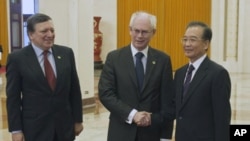 Chinese Premier Wen Jiabao, right, shakes hand with EU President Herman Van Rompuy beside European Commission President Jose Manuel Barroso before their meeting at the Great Hall of the People in Beijing , Feb. 14, 2012.