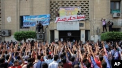 Student protesters hold a rally at Cairo University in Cairo, Egypt, Sunday, Oct. 12, 2014.