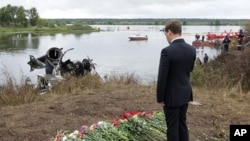 Russian President Dmitry Medvedev pays last respects at a plane crash site near Yaroslavl, on the Volga River about 150 miles (240 kilometers) northeast of Moscow, September 8, 2011.