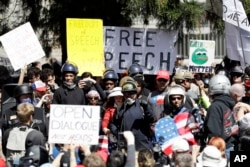 A crowd gathers around speakers during a rally for free speech April 27, 2017, in Berkeley, Calif.