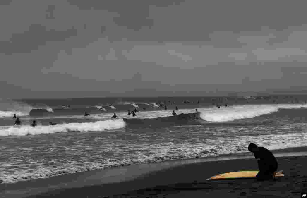 People enjoy surfing in Fujisawa, near Tokyo, Japan.