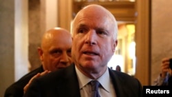 FILE - U.S. Senator John McCain (R-AZ) leaves after Senator Dianne Feinstein's (D-CA) speech on the Senate floor on Capitol Hill, in Washington, Dec. 9, 2014.