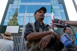 On this picture taken on March 29, 2017, Mexican photojournalist Margarito Martinez is interviewed as journalists from Baja California State demonstrate against violence towards members of the press in Mexico, outside the Office of the Mexican Attorney-Ge