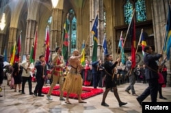 FILE - Flags of the Commonwealth being paraded through the Abbey at the Commonwealth Service at Westminster Abbey, in London, March 12, 2018.