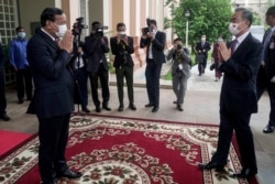 FILE - China's Foreign Minister Wang Yi (R) greets Cambodia's Foreign Minister Prak Sokhonn for a meeting at the Ministry of Foreign Affairs in Phnom Penh on Sept. 12, 2021. (Kith Serey / Pool / AFP)