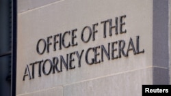 A sign of the Office of the Attorney General is displayed on the Department of Justice building the day after Special Counsel Robert Mueller delivered his report into Russia's role in the 2016 U.S. election. 
