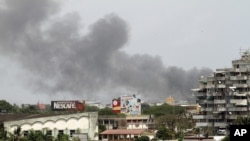 Smoke rises from the city centre of Abidjan April 1, 2011 as fierce fighting spread across the city.