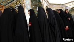 FILE - Women stand in line to vote during the Iranian presidential election at a mosque in Qom, 120 km (74.6 miles) south of Tehran, June 14, 2013. 