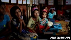 FILE - In this Aug. 27, 2018, photo, Rohingya refugee children attend a UNICEF run school in Balukhali refugee camp, Bangladesh. (AP Photo/Altaf Qadri)