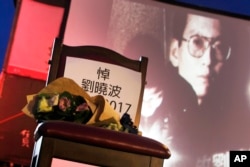 A bouquet of flowers is placed on a chair that reads ''Mourning Liu Xiaobo'' in front of his image during a ceremony to mourn late Nobel Peace Prize laureate Liu, often called China's most famous political prisoner, at Democracy Square in Taipei, Taiwan, July 14, 2017.