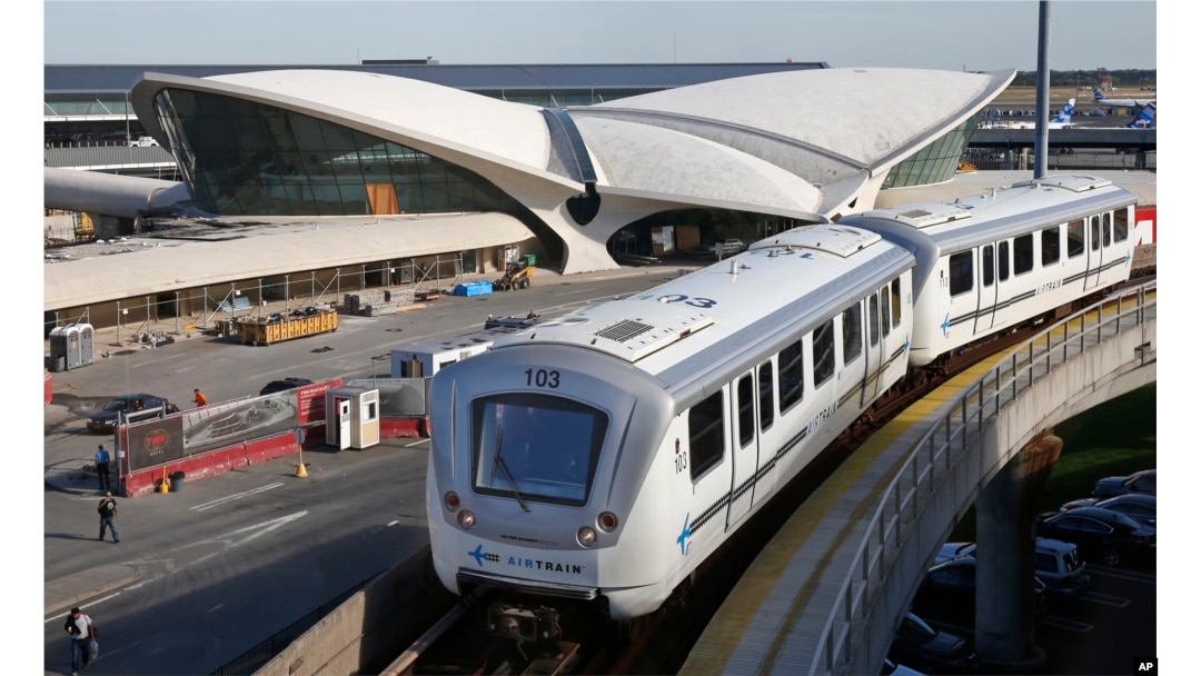 In this Oct. 10, 2017 photo, an AirTrain passes the TWA Hotel at New York's John F. Kennedy International Airport.