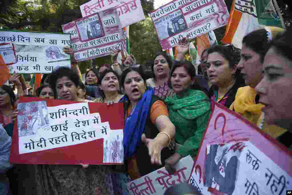 India’s opposition Congress party’s women activists shout slogans during a protest after a woman was allegedly raped by a taxi driver in New Delhi, India, Monday, Dec. 8, 2014.