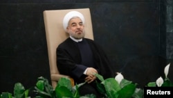 Iran's President Hassan Rouhani waits to address the United Nations General Assembly at U.N. headquarters. Sept. 24, 2013 