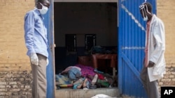 Staff open the doors of the morgue at the teaching hospital to add another body to the 24 already there, 20 of whom were killed from violence according to the staff, in Malakal, Upper Nile State, in South Sudan, Jan. 21, 2014