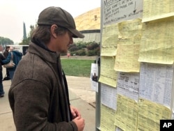 Wildfire evacuee Greg Gibson looks for information about his missing neighbors at The Neighborhood Church in Chico, California, Nov. 13, 2018.