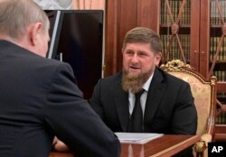 FILE - Russian President Vladimir Putin, left, meets with Chechnya's regional leader Ramzan Kadyrov in the Kremlin in Moscow, Russia, April 19, 2017.