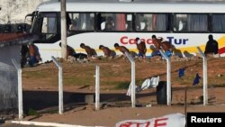 Inmates line up near riot police at Alcacuz prison in Natal, Rio Grande do Norte state, Brazil, Jan. 18, 2017.