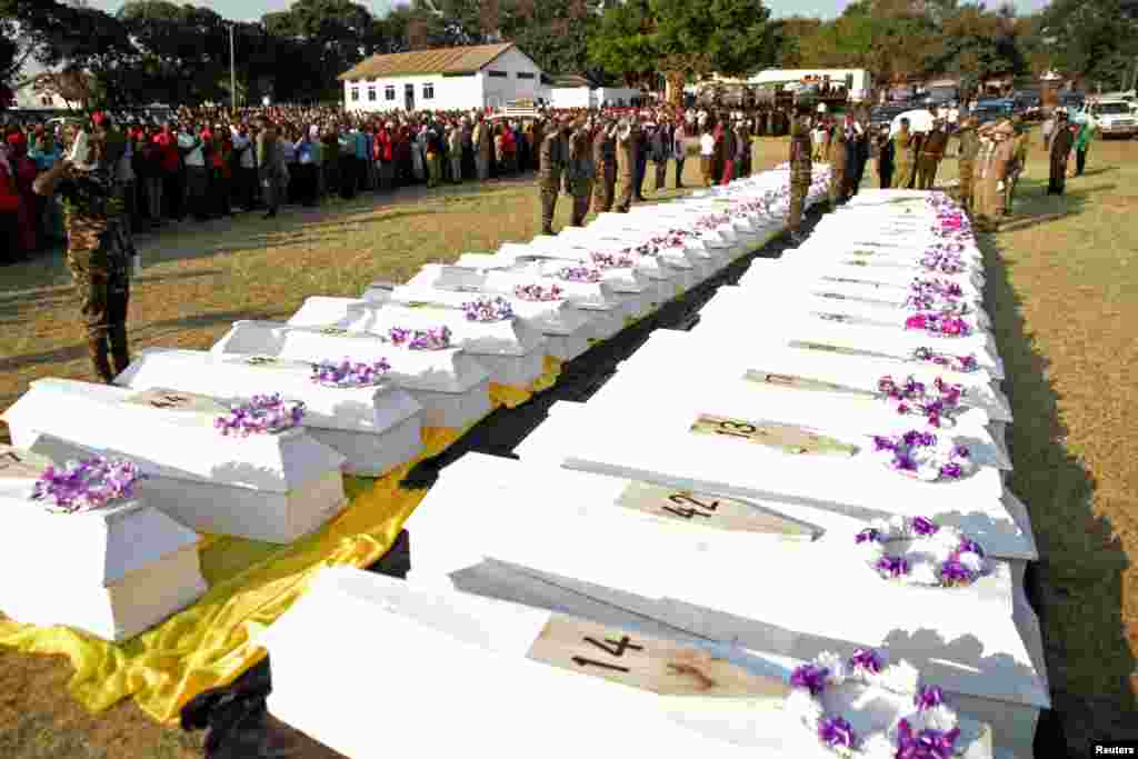 Members of military prepare to bury the bodies of people killed after a fuel tanker exploded in Morogoro, eastern Tanzania. More than 60 people were killed as flames ripped through a crowd that had gathered to siphon petrol from the tanker, authorities said.