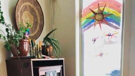 In this April 2, 2020, photo provided by Cassy Quinlan, 4-year-old Polly Fraley listens in Homer, Alaska, to children's stories being read on air at local radio station KBBI by librarian Claudia Haines.