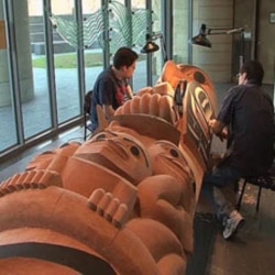 David Boxley works at the National Museum of the American Indian in Washington on one of the totem poles that he created with his son