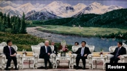 U.S. Vice President Joe Biden (center, L) talks with Chinese Vice President Li Yuanchao (center, R) after a welcoming ceremony at the Great Hall of the People in Beijing, Dec. 4, 2013. 