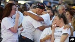 Friends and family grieve during a vigil to honor Pulse night club victim Corey Connell at Publix in College Park, Fla., on Thursday, June 16, 2016. (Stephen M. Dowell (Orlando Sentinel via AP)