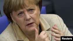 German Chancellor Angela Merkel attends a debate after delivering a statement on her government policies ahead of the upcoming G8 and NATO summits Bundestag, in Berlin, May 10, 2012.