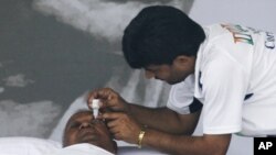 A volunteer administers eye drops to Indian social activist Anna Hazare on day 11 of his fast at the Ramlila grounds in New Delhi, Aug. 26, 2011.