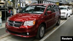 FILE - Fiat Chrysler's Dodge minivans move down the final production line at the Windsor Assembly Plant in Windsor, Ontario, February 9, 2015.