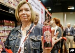 Berkshire Hathaway shareholder Barb Whitelock of Omaha stands in line to buy a commemorative Coca Cola can made for the Chinese market that features the likeness of Warren Buffett, at the CenturyLink Center in Omaha, Neb., May 5, 2017.
