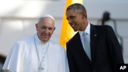 FILE - President Barack Obama leans over to talk to Pope Francis during a state arrival ceremony on the South Lawn of the White House in Washington, Sept. 23, 2015.