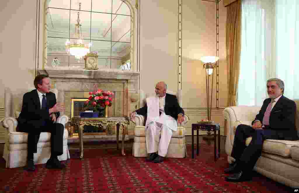 Afghanistan's president Ashraf Ghani Ahmadzai and Afghanistan's chief executive Abdullah Abdullah listen to Britain's Prime Minister David Cameron during their meeting at the presidential palace in Kabul, Afghanistan, Oct. 3, 2014.