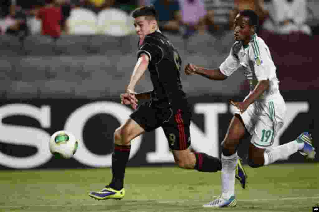 Mexico's, Alejandro Diaz, left, and Nigeria's Zaharaddeen Bello compete for the ball during the World Cup U-17 final soccer match between Nigeria and Mexico at Mohammad Bin Zayed stadium in Abu Dhabi, United Arab Emirates, Friday, Nov. 8, 2013. (AP Photo/