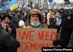 A supporter of Ukraine's former leader Petro Poroshenko holds a placard as he attends a rally in Kyiv on Jan. 17, 2022.