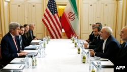 US Secretary of State John Kerry (L) meets with Iranian Foreign Minister Javad Zarif (2R) in Vienna, Austria on Jan. 16, 2016, on what is being referred to as "implementation day," the day the IAEA verifies that Iran has met all conditions under the nuclear d