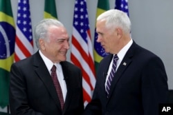 Brazil's President Michel Temer (L) greets U.S. Vice President Mike Pence at Planalto Palace, in Brasilia, Brazil, June 26, 2018.