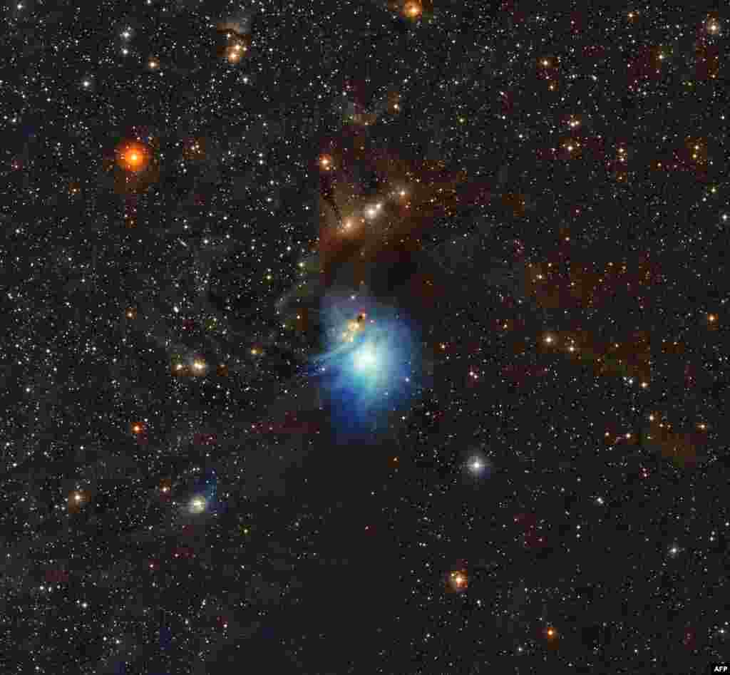 A handout photo released by the European Southern Observatory shows a newly formed star lighting up the surrounding cosmic clouds in this image from ESO&rsquo;s La Silla Observatory in Chile.